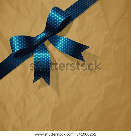 Polka Dots dark blue pearl ribbon on a crumpled paper brown background.