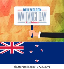 Polygonal Background and New Zealand Waaitangi Day Concept Greeting Card. Hand Hold Signboard