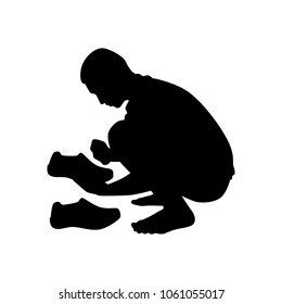 The poor young man clean the shoes silhouette vector