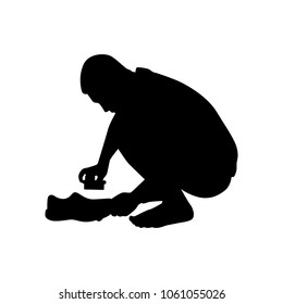 The poor young man clean the shoes silhouette vector