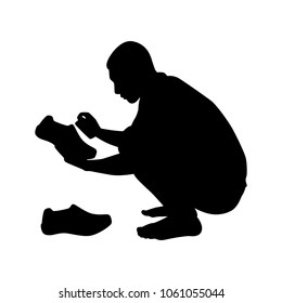 The poor young man clean the shoes silhouette vector