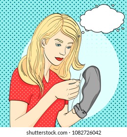 pop art background, point. Young, the girl sews men's black socks with a needle and thread. Imitation comic style, retro, vector illustration text bubble