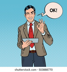 Pop Art Businessman with Tablet Gesturing OK and Winking. Vector illustration