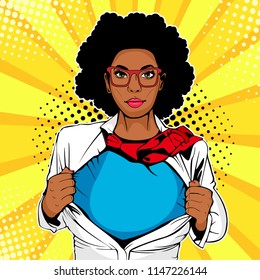Pop art female afro american superhero. Young sexy woman dressed in white jacket shows superhero t-shirt. Vector illustration in retro pop art comic style.