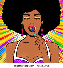Pop art female face. Sexy african american woman with afro hair, closed eyes, open mouth, bright rainbow lollipop in form of heart in her hand. Vector background in pop art retro comic style. 