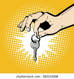 Pop art hand holding a house key. Comic hand drawn romantic illustration - man makes a present. Vector isolated on yellow halftone background.