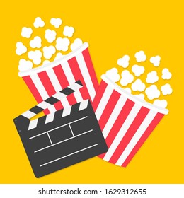 Popcorn. Big open clapper board. Two pop corn box set. Cinema red white lined box icon. Movie night. Fast food. Flat design style. Yellow background. Isolated. Vector illustration