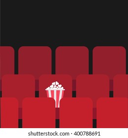 Popcorn box on red seat. Movie theater hall. Film show Cinema background. Flat design Vector illustration