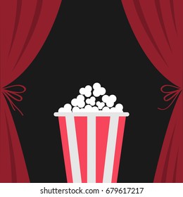 Popcorn box. Open luxury red silk stage theatre curtain. Velvet scarlet curtains with bow. Fast food. Flat design. Movie cinema premiere icon. Template. Black background. Vector illustration