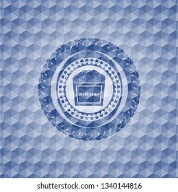 popcorn icon inside blue emblem or badge with geometric pattern background.