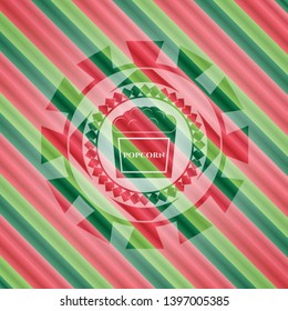 popcorn icon inside christmas badge background.