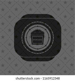 popcorn icon inside dark emblem
