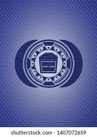 popcorn icon inside emblem with jean background