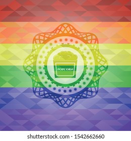 popcorn icon inside emblem on mosaic background with the colors of the LGBT flag