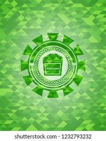 popcorn icon inside green emblem with mosaic ecological style background