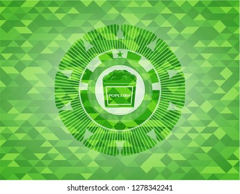 popcorn icon inside green emblem with mosaic background