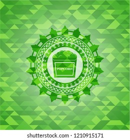 popcorn icon inside green mosaic emblem