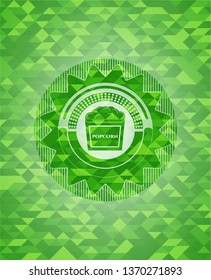 popcorn icon inside green mosaic emblem