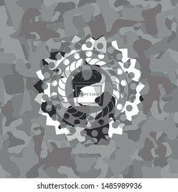 popcorn icon inside grey camouflage emblem