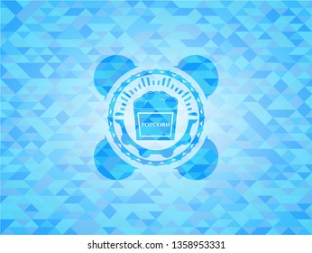 popcorn icon inside light blue emblem with mosaic background