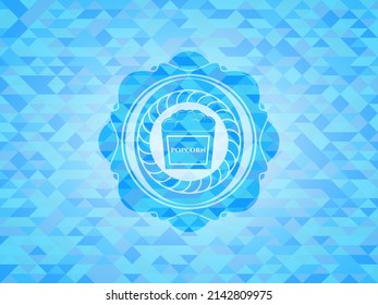 popcorn icon inside light blue emblem with mosaic background. 