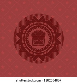 popcorn icon inside red emblem