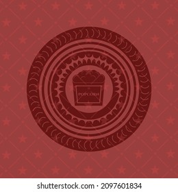 popcorn icon inside red icon or emblem. 