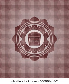 popcorn icon inside red seamless badge with geometric background.
