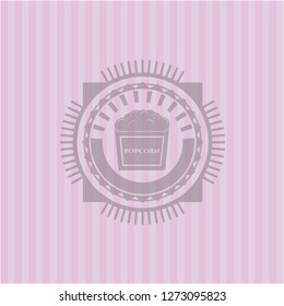 popcorn icon inside retro pink emblem