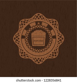 popcorn icon inside retro wood emblem