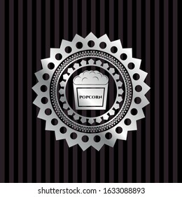 popcorn icon inside silver badge or emblem