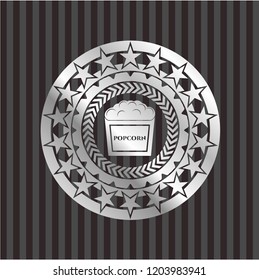 popcorn icon inside silver emblem