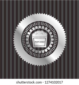 popcorn icon inside silver emblem