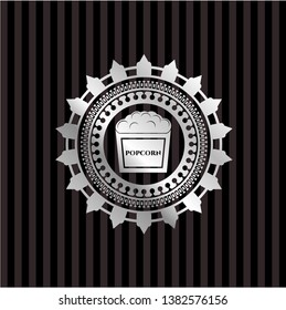 popcorn icon inside silver emblem