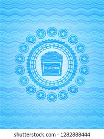popcorn icon inside sky blue water emblem background.