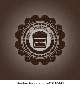 popcorn icon inside wooden emblem. 