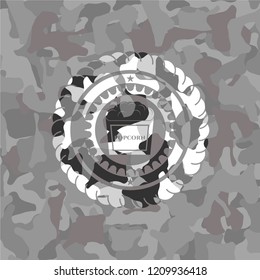 popcorn icon on grey camouflaged pattern