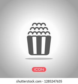 Popcorn icon, snack for movie, paper box of food. Icon under spotlight. Gray background