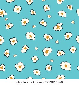 Popcorn vector seamless pattern on blue background. Popcorn is a delicious snack that you enjoy while watching movies.