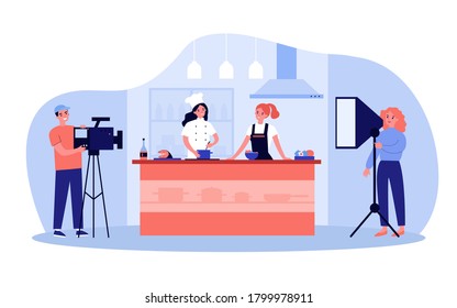 Popular cooking show concept. Camera man and stage manager shooting smiling chefs cooking and talking at kitchen counter. For TV show production, television, coking contest topics