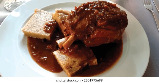 Pork ribs with polenta in white plate