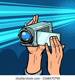 portable hand-held video camera. Pop art retro vector illustration kitsch vintage 50s 60s