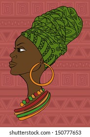 Portrait of beautiful African girl in a headscarf on an ethnic patterned background
