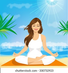 portrait of a beautiful young woman sitting in yoga pose at the beach