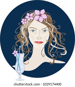 Portrait of a brunette girl with pink flowers and a glass on a blue background