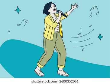 Portrait of carefree Asian woman, having fun karaoke, singing in microphone while standing over blue background