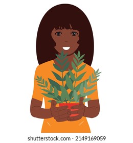 Portrait of a girl holding a potted flower in her hands. Ecology.