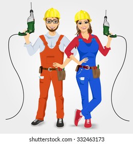 portrait of handyman and handywoman holding green drills isolated on white background