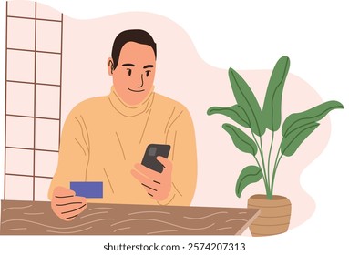 Portrait of a happy middle-aged man making an online payment with a credit card using his smartphone. He is seated at a dining table in a cozy, modern setting