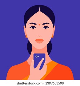 Portrait of an Indian girl holding a mobile phone in her hand. Avatar female. Addiction on the Internet and social networks. Vector Flat Illustration